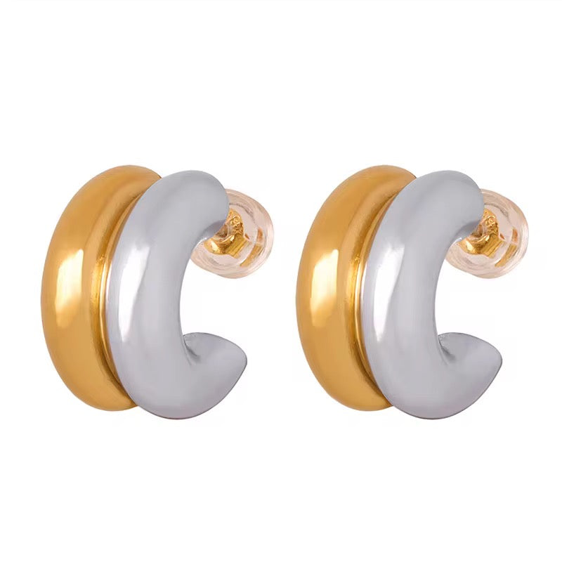 Pair of gold and white hoop earrings on a white background