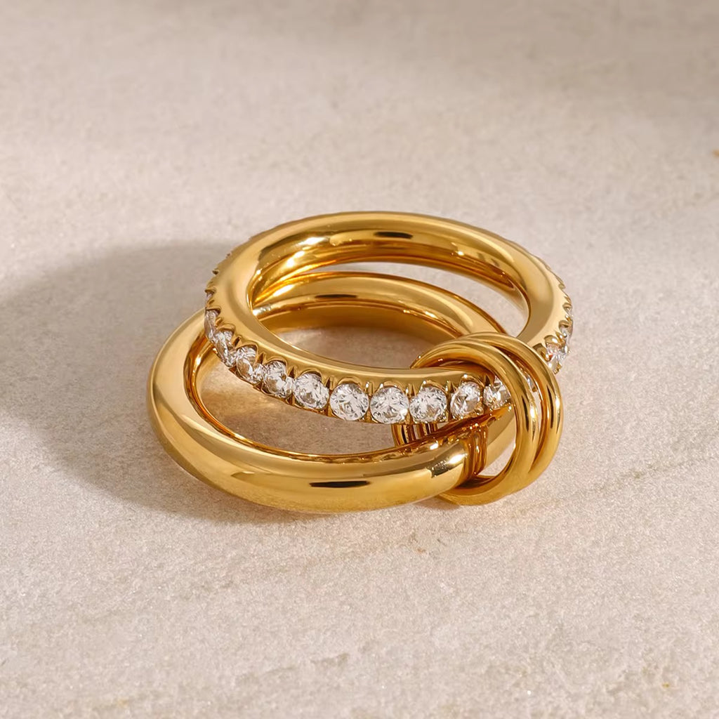 Gold ring with diamond accents on a beige background