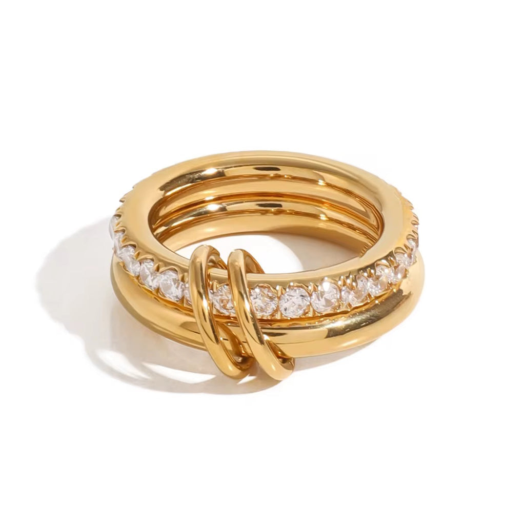 Gold ring with diamond accents on a white background