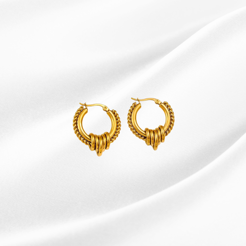 Pair of gold hoop earrings on a white background