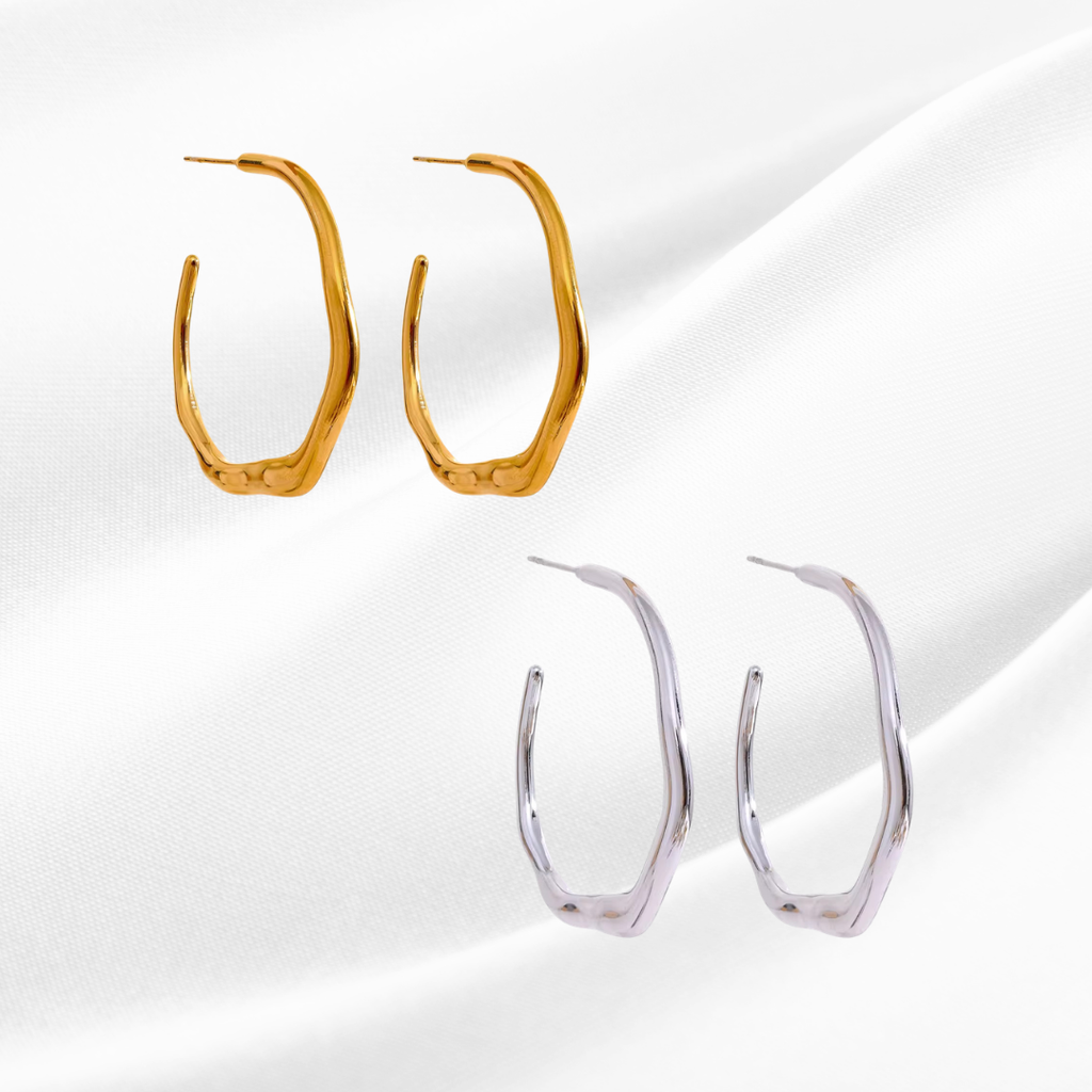 Gold and silver hoop earrings on a white background