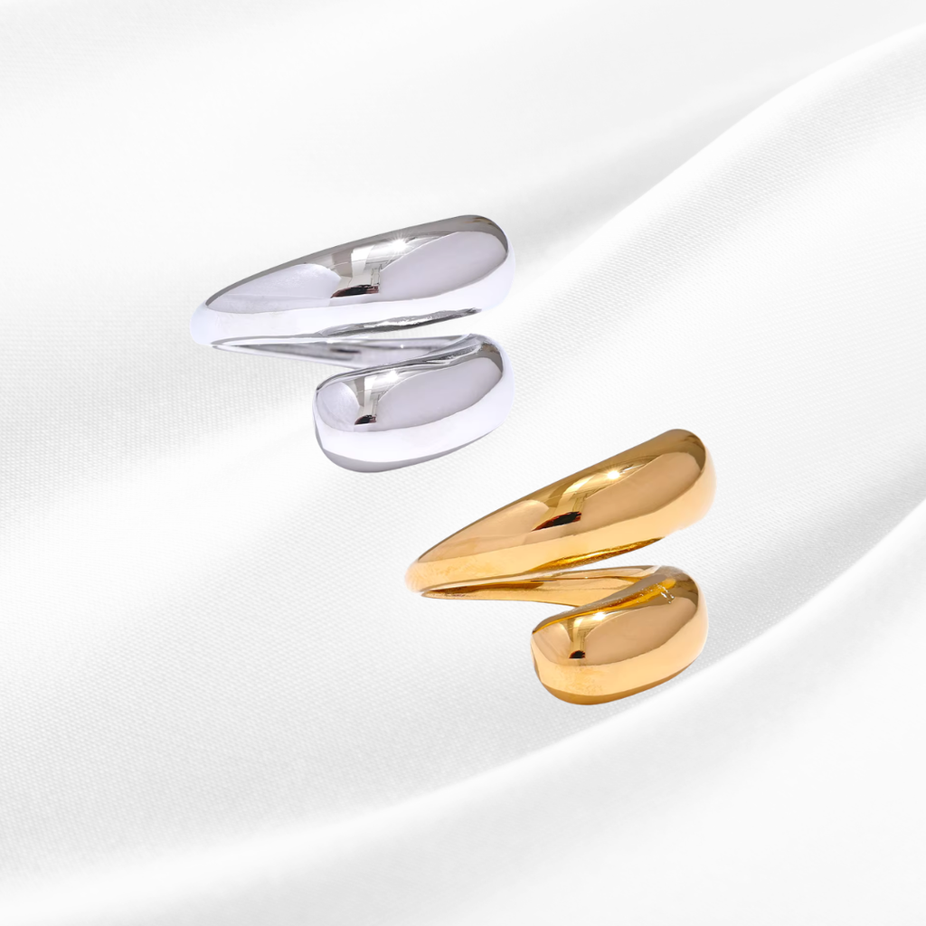Gold and silver spiral earrings on a white background