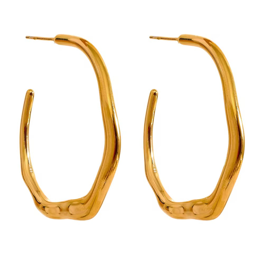 Gold hoop earrings on a white background