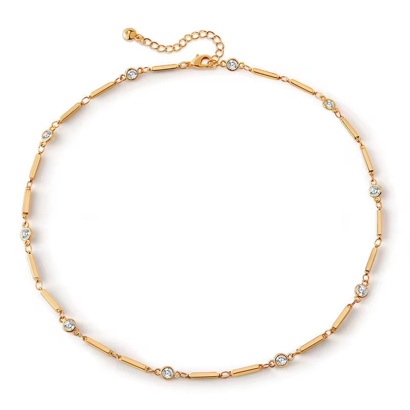 Gold bracelet with small crystals on a white background