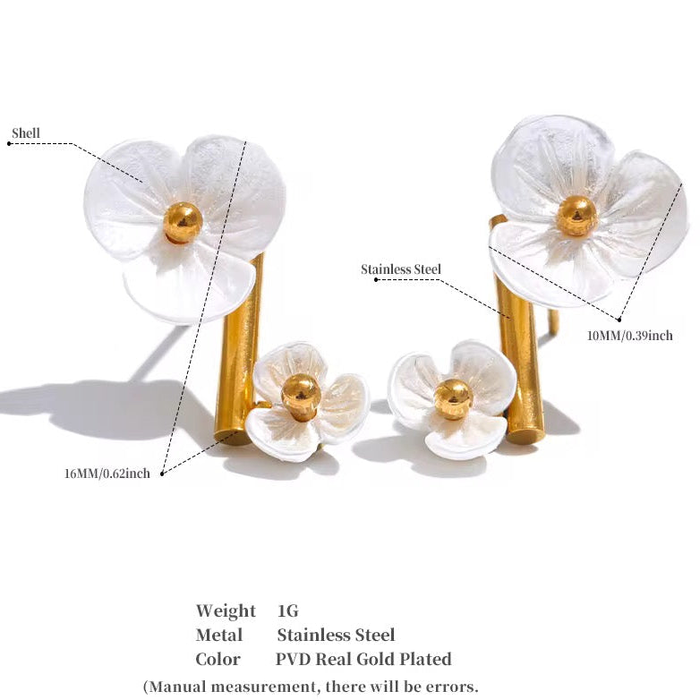 White floral earrings with gold accents on a white background