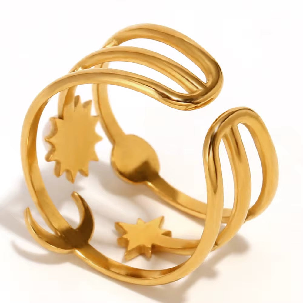 Gold bracelet with sun, moon, and star designs on a white background