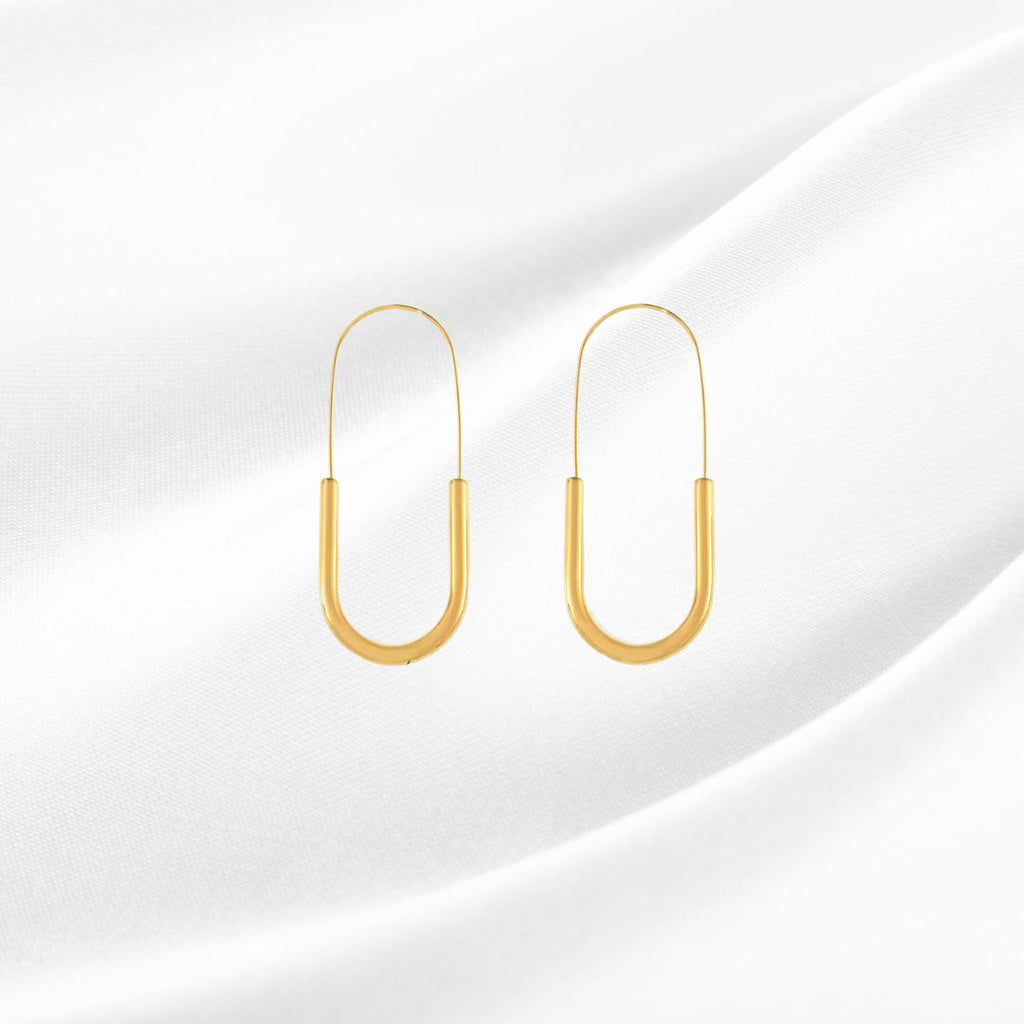 Gold hoop earrings on a white background