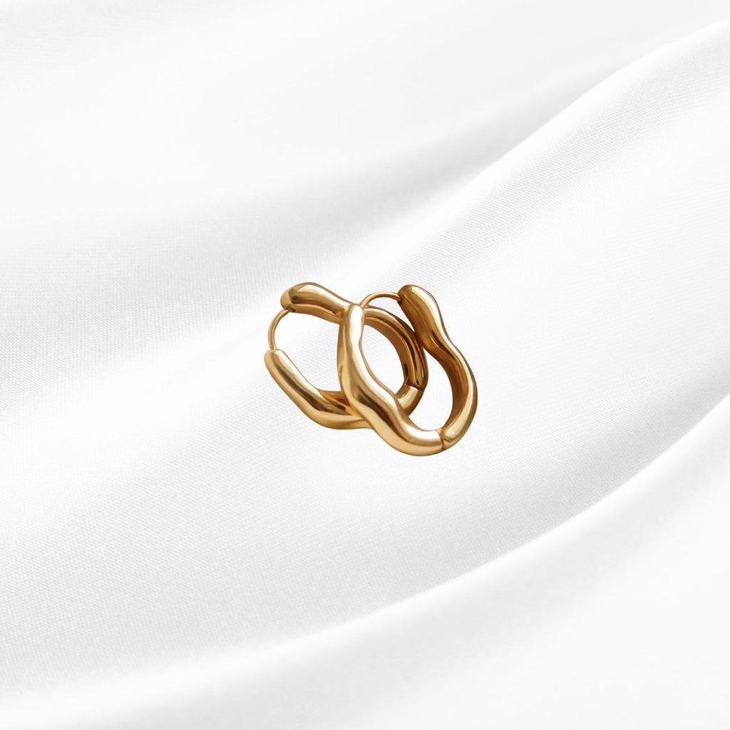 Gold hoop earrings on a white background