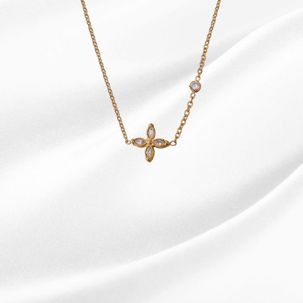 Gold butterfly pendant necklace on a white background