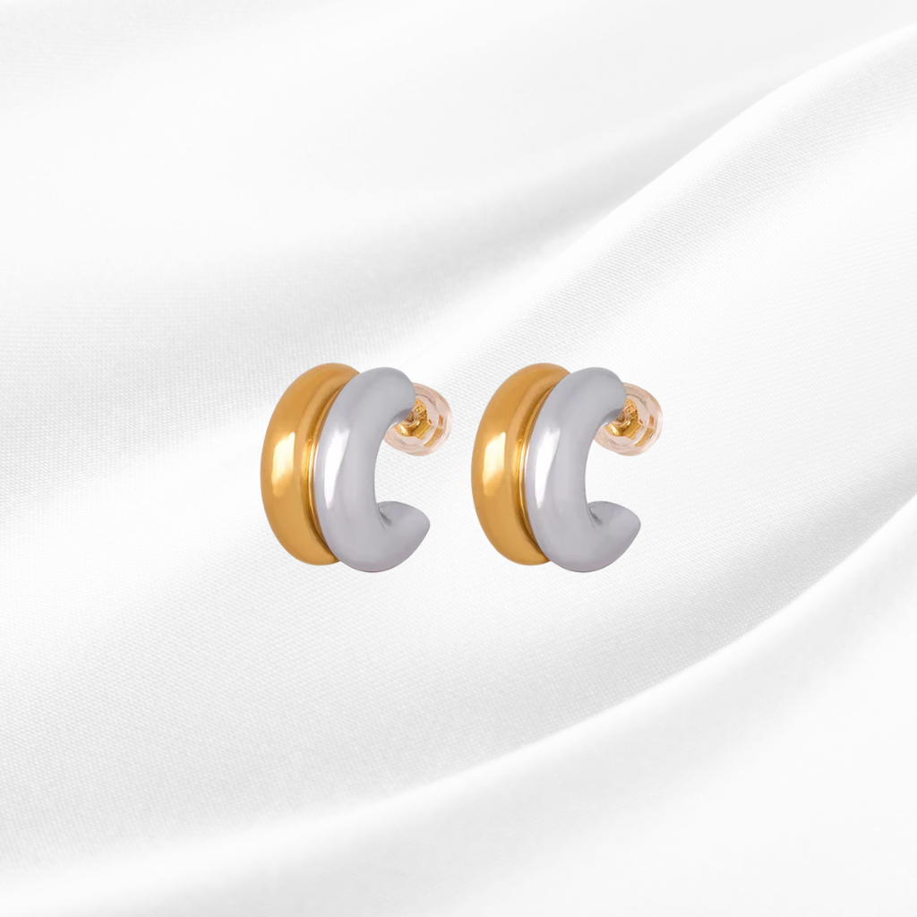 Pair of gold and silver earrings on a white background