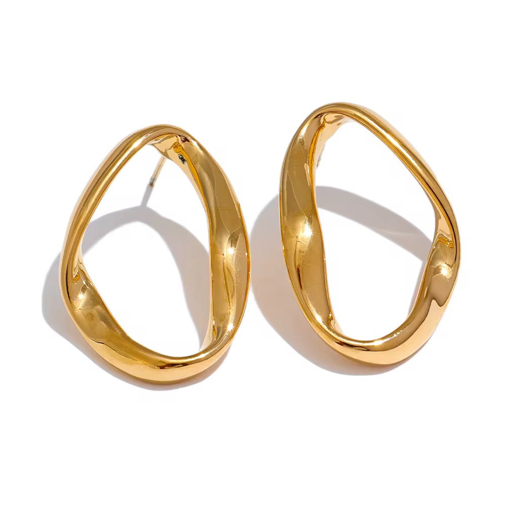 Gold hoop earrings on a white background