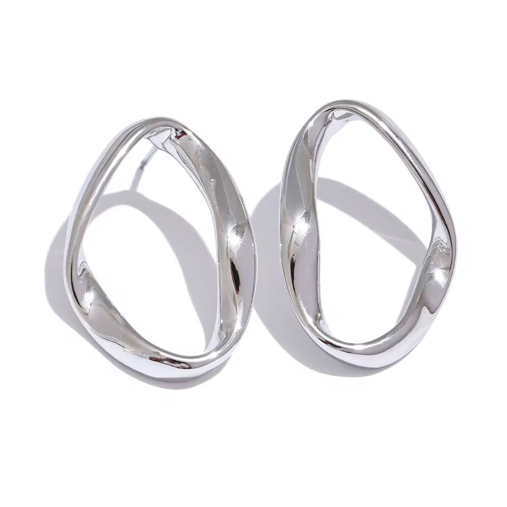 Pair of silver hoop earrings on a white background